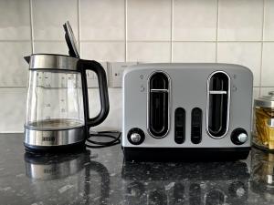 a toaster sitting on a counter next to a blender at Cosy City Centre Townhouse in Elswick