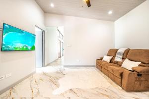 a living room with a couch and a flat screen tv at Casa Montana Azul @ Catalina Cove in Brasilito