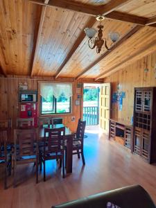 a dining room with a table and chairs at Hostal Robinson in Puerto Puyuhuapi