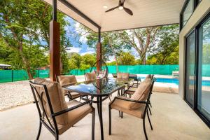 a patio with a table and chairs and a pool at Casa Montana Azul @ Catalina Cove in Brasilito