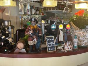 a statue of a person sitting on a counter in a store at L'Ex-Voto in Honfleur