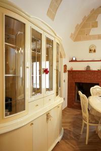 a dining room with a table and a fireplace at Casa Vacanze San Pietro in Canosa di Puglia