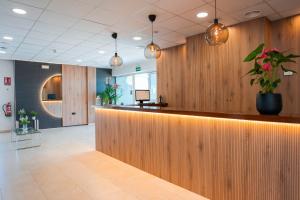 a lobby with a bar with a plant on it at Hotel Caravaca Resort in Caravaca de la Cruz +62 photos
