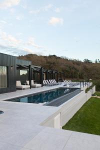 a swimming pool with chairs and a house at The Fox by LovelyStay in Sobral de Monte Agraço