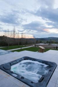 a hot tub sitting on top of a patio at The Fox by LovelyStay in Sobral de Monte Agraço