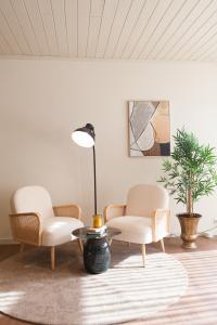 a living room with two chairs and a table at The Fox by LovelyStay in Sobral de Monte Agraço
