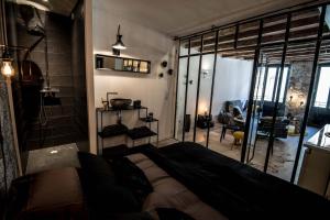 a bedroom with a large bed and a large window at "Un Lieu Unique" le Gold et le Cocon in Annecy