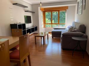 a living room with a couch and a table at Dacarreda in Villamayor