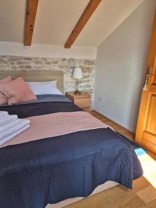 a bedroom with a king sized bed in a room at Akvamarin Stone House Istria in Medulin