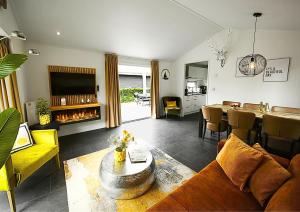 a living room with a couch and a table with a fireplace at Beachhouse Strandglück nur ca 100m bis zum Strand in Hulshorst