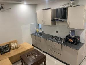 a kitchen with a stove and a counter top at Subleasing Pakistan in Rawalpindi