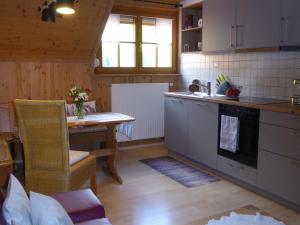 a kitchen with a table and a stove top oven at Haus am Rotwiesenbach in Todtnau