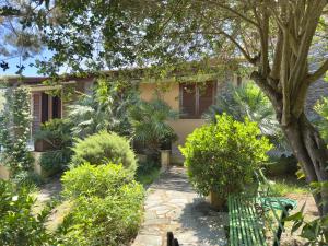 a house with trees and plants in front of it at Residence L'Ancora - Stintino in Stintino