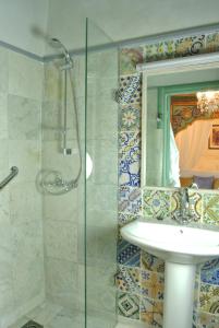 a bathroom with a sink and a glass shower at Dar Ben Gacem in Tunis +92 photos