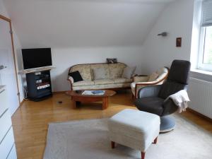 a living room with a couch and a chair at Natur pur in Bad Pyrmont
