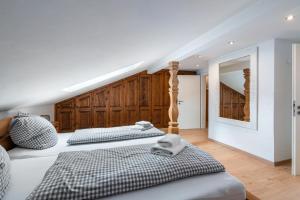 a bedroom with two beds and a mirror at Haus Kreiznegge in Inzell