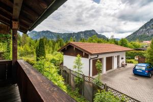 a house with a car parked on a balcony at Haus Kreiznegge in Inzell