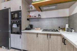 a kitchen with a stove and a refrigerator at Four 4Season - Beach Access & Amazing View Retreat in Vraná