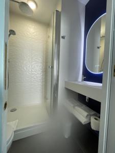 a bathroom with a shower and a toilet and a sink at Best Western Hôtel Royan Océan in Royan