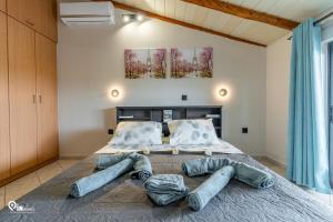 a bedroom with a large bed with pillows on it at 'Four 4Season' With Amazing View in Vraná