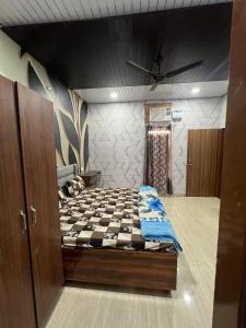 a bedroom with a bed with a checkerboard pattern at Lovish apartment in Jāmb +1 photo