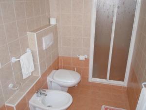 a bathroom with a toilet and a sink and a shower at Albergo Elvira in Tabiano