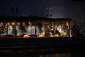 a restaurant with a table and chairs and lights at Shellghada Blue Beach in Hurghada