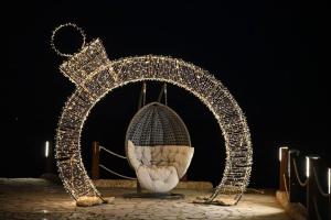 an arch covered in christmas lights on a stage at Shellghada Blue Beach in Hurghada