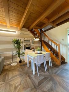 a kitchen and dining room with a table and chairs at Green Garda Holidays - Garda Lake in Castelnuovo del Garda