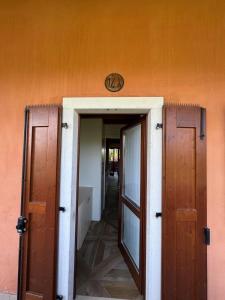 an entrance to a building with an orange wall at Green Garda Holidays - Garda Lake in Castelnuovo del Garda