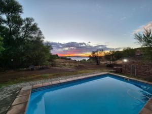a swimming pool with a view of the water at Fish Eagles Nest in Gariep Dam