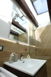 a bathroom with a sink and a mirror at Centro storico apartment & Loft - Amnesia Holiday Home in Palermo +106 photos