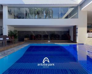 an image of an outdoor swimming pool with a hotel logo on it at Arituba Park Hotel in Natal