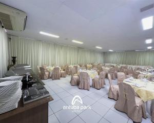 a large banquet hall with tables and chairs in it at Arituba Park Hotel in Natal
