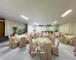 a banquet hall with tables and chairs in a room at Arituba Park Hotel in Natal