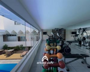 a fitness room with a swimming pool and a gym at Arituba Park Hotel in Natal