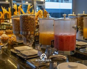 a counter with three containers of different types of food at Arituba Park Hotel in Natal