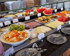 a buffet filled with different types of cheese and fruit at Arituba Park Hotel in Natal