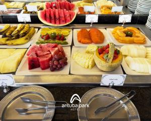 a display case with many different types of fruits and vegetables at Arituba Park Hotel in Natal +37 photos