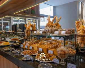 a buffet line with bread and pastries on display at Arituba Park Hotel in Natal