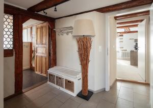 a living room with a bench and a lamp at Seehaus Allensbach - Riviera Suite in Allensbach