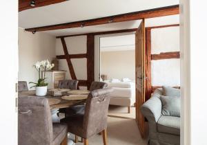 a dining room with a table and chairs at Seehaus Allensbach - Riviera Suite in Allensbach +17 photos