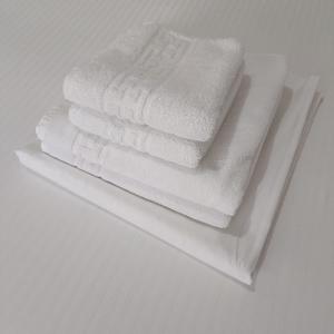 a stack of white towels on a white shelf at Peter et Len Soleil , Famille in Eforie Nord