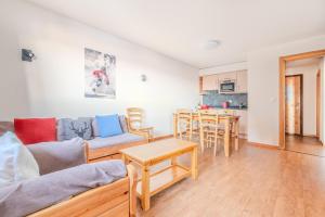 a living room with a couch and a table at Pracondu 1 304 - OUTDOOR & FUN charming apartment in Nendaz