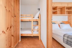 a small room with bunk beds and a bed at Pracondu 1 304 - OUTDOOR & FUN charming apartment in Nendaz