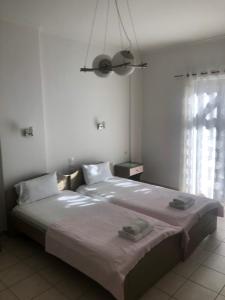 A bed or beds in a room at Amalia Hotel