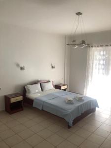 A bed or beds in a room at Amalia Hotel