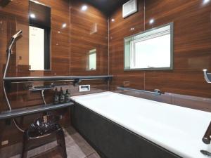 a large bathroom with a large tub and a shower at Little Deer by SANA in Tateyama