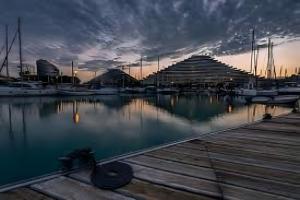 a marina with boats in the water at sunset at Appartement Dans Villa in Villeneuve-Loubet