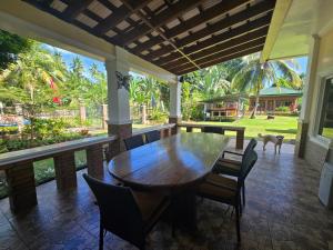 a dining room with a wooden table and chairs at Bregman Residance in Plaridel